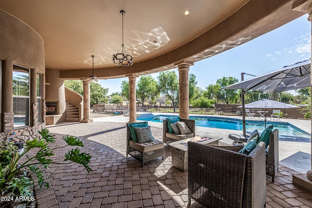 view of patio featuring a fenced in pool and an outdoor fireplace