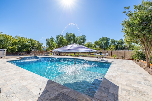 view of pool with pool water feature and a patio area