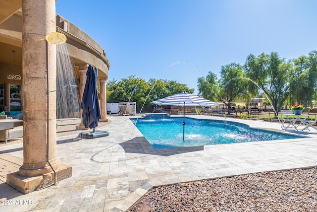 view of pool with pool water feature and a patio area