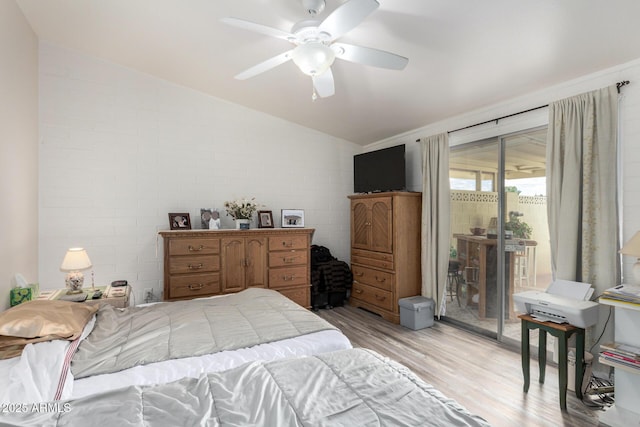 bedroom featuring light wood-type flooring, ceiling fan, access to outside, and vaulted ceiling