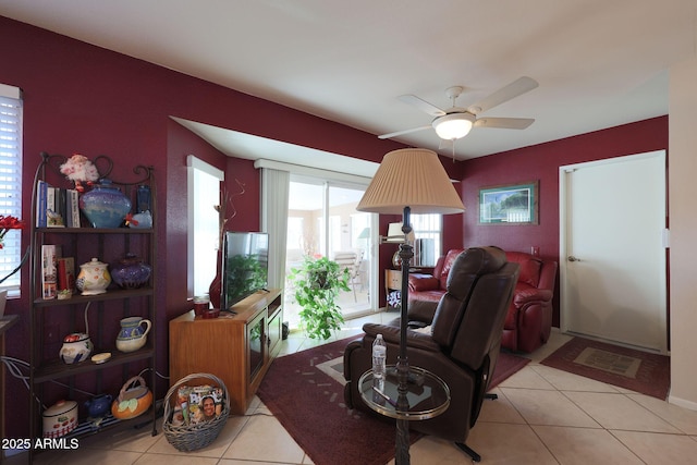 living room with light tile patterned floors and ceiling fan