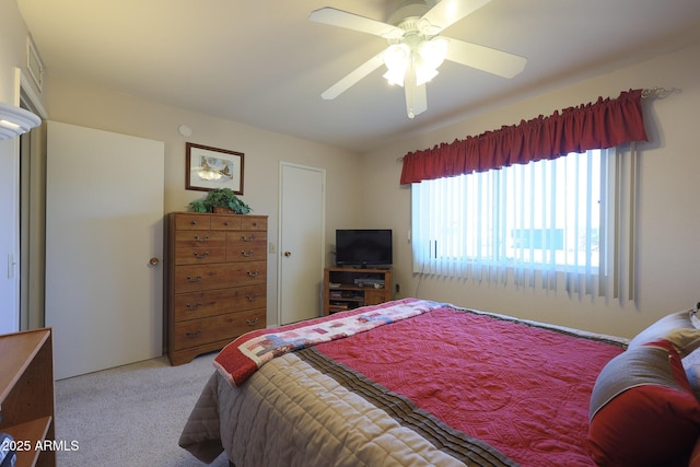 bedroom featuring light carpet and ceiling fan