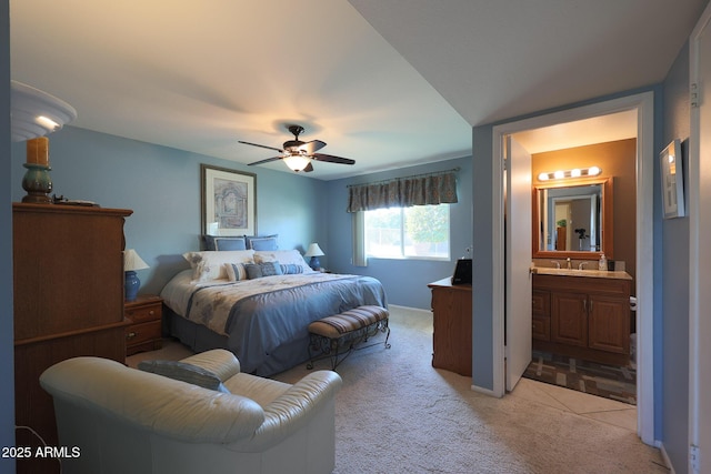 carpeted bedroom with sink, ceiling fan, and ensuite bathroom