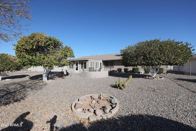 back of property with a sunroom