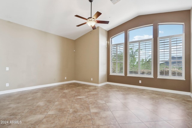 tiled empty room featuring ceiling fan and lofted ceiling