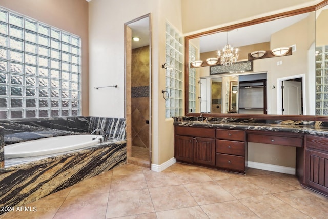 bathroom with vanity, a chandelier, plus walk in shower, and tile patterned floors