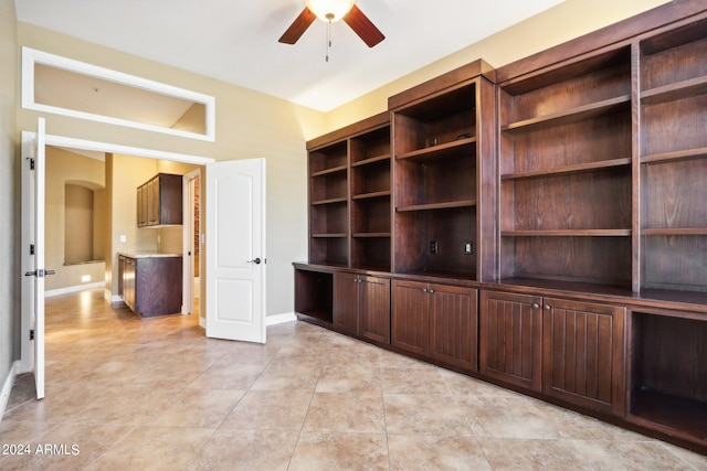 unfurnished living room featuring ceiling fan