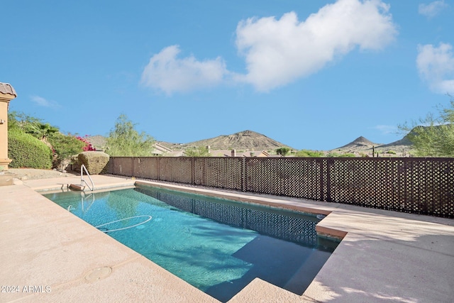 view of pool featuring a mountain view and a patio area