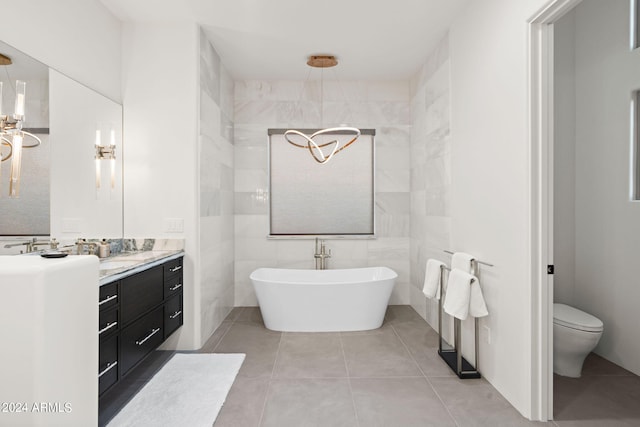 bathroom featuring a bathtub, tile walls, vanity, tile patterned flooring, and toilet