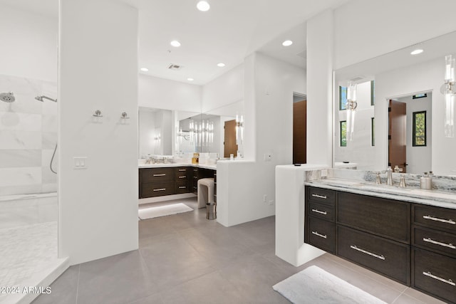 bathroom featuring tiled shower and vanity