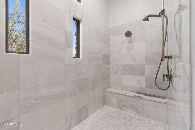 bathroom with tiled shower