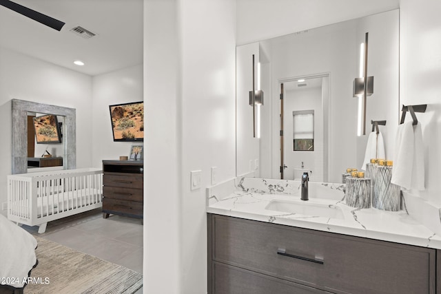 bathroom featuring ceiling fan, vanity, and tile patterned floors