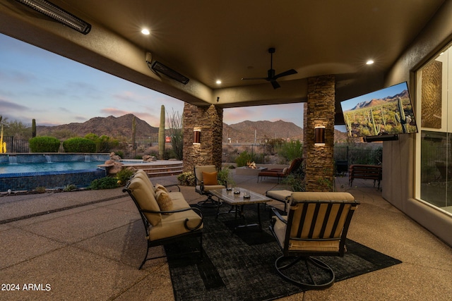 view of patio featuring ceiling fan and a fenced in pool