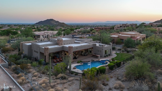 aerial view at dusk featuring a mountain view