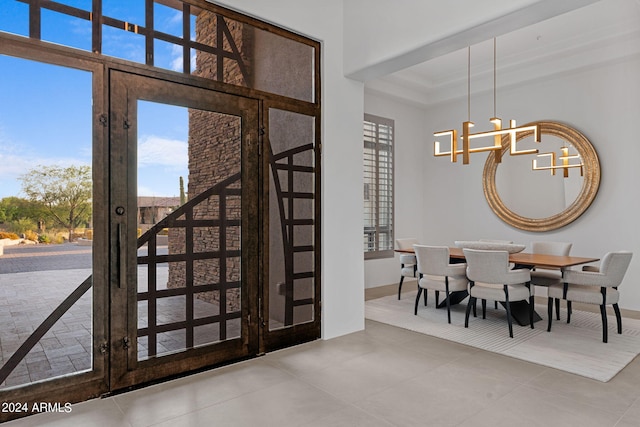 dining area featuring an inviting chandelier and light tile patterned floors