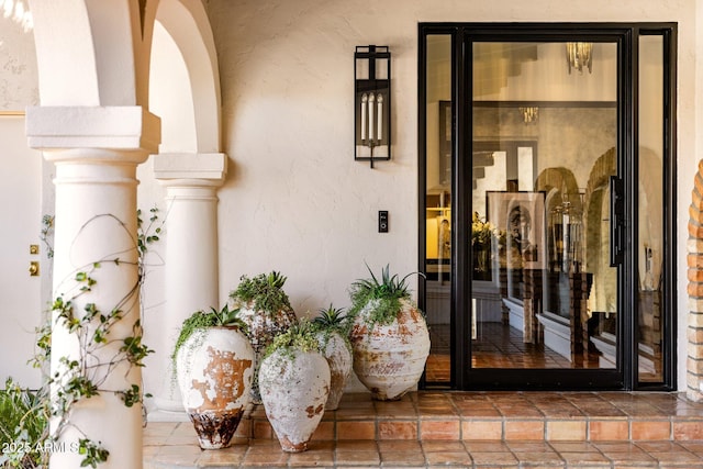 property entrance with stucco siding