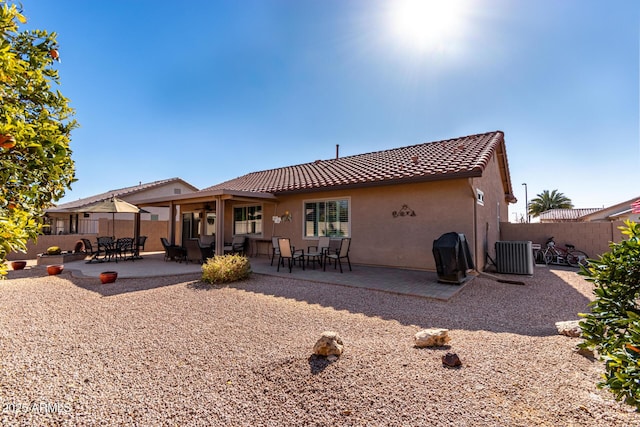 rear view of property featuring central AC and a patio area