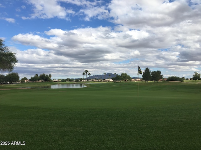 view of property's community with a water view and a yard