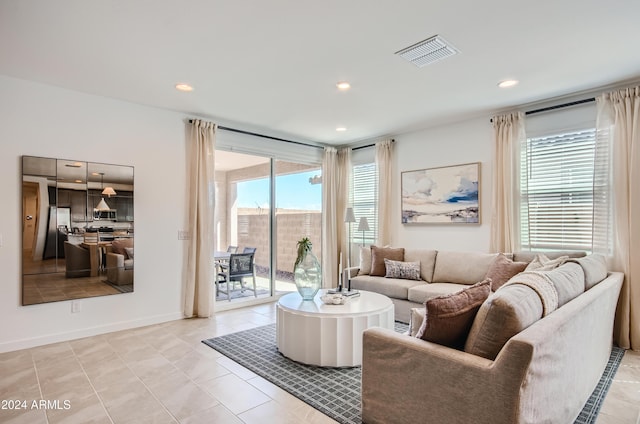 living room with plenty of natural light and light tile patterned floors