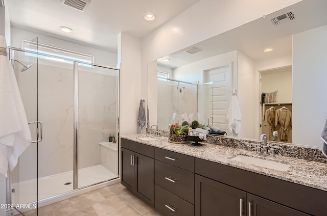 bathroom featuring vanity and an enclosed shower