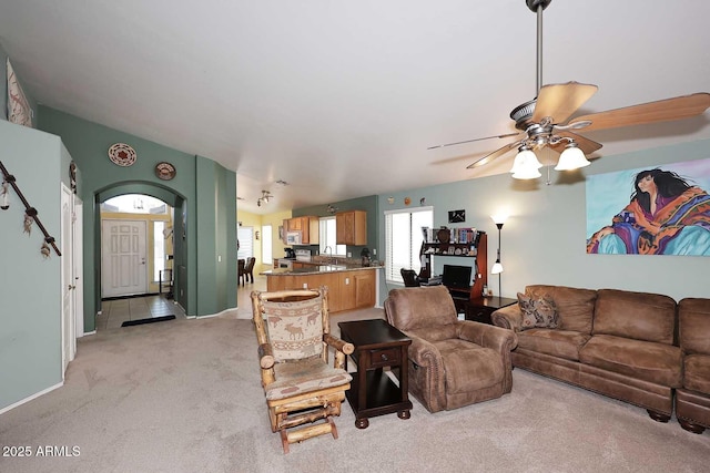 living room with sink, ceiling fan, and light colored carpet