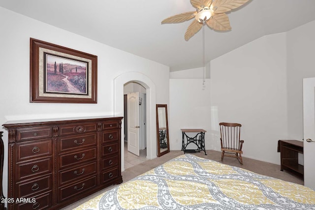 carpeted bedroom with vaulted ceiling and ceiling fan