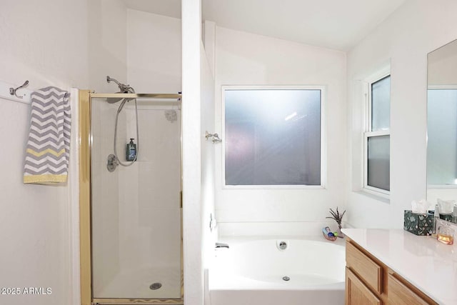 bathroom featuring separate shower and tub, vaulted ceiling, and vanity