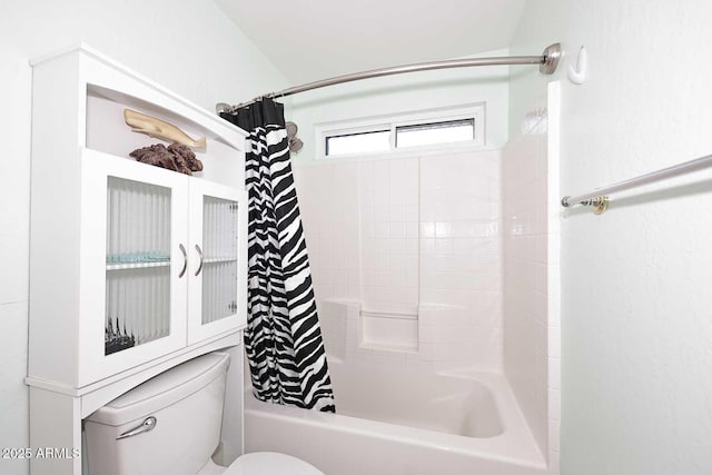 bathroom with toilet and shower / bath combo with shower curtain