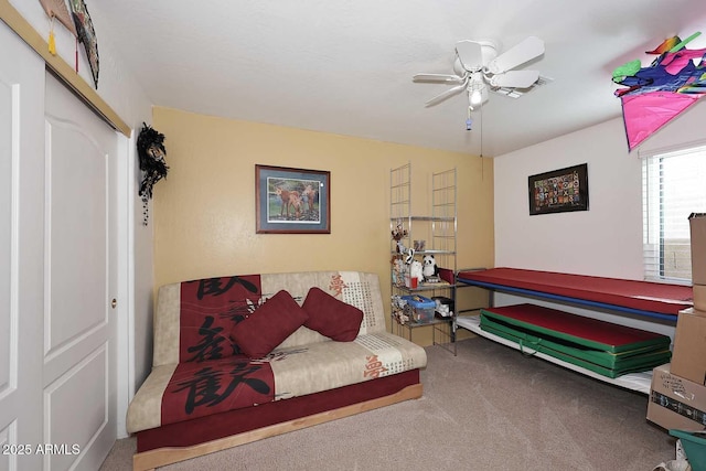 interior space featuring ceiling fan and carpet