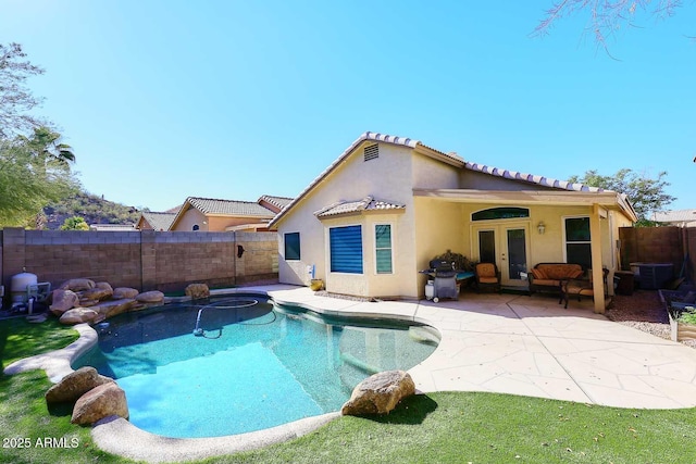 back of house featuring a patio and french doors