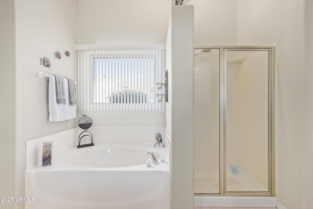 bathroom featuring shower with separate bathtub