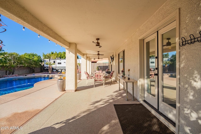 view of pool with ceiling fan and a patio area