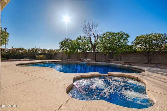 view of swimming pool featuring an in ground hot tub and a patio area