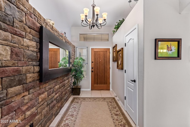 entryway featuring an inviting chandelier and light tile patterned flooring