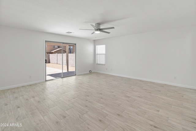 unfurnished room with ceiling fan and light wood-type flooring