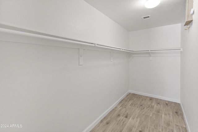 walk in closet featuring light hardwood / wood-style flooring