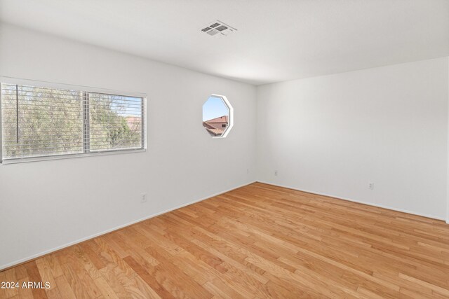 unfurnished room featuring light hardwood / wood-style floors