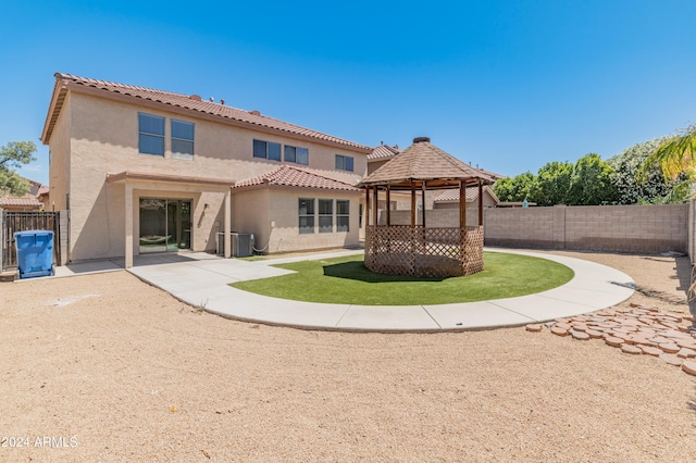 back of house with a gazebo, a patio, and central AC