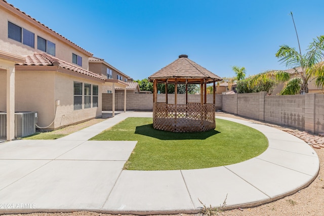 view of yard featuring a gazebo, central AC, and a patio