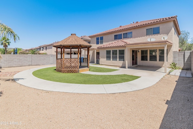 back of property featuring a gazebo