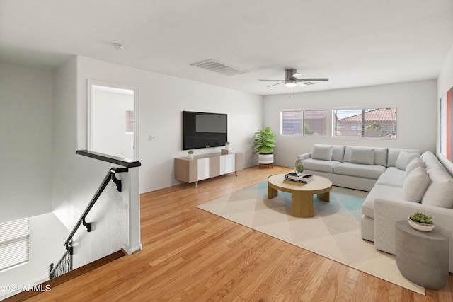 living room featuring light hardwood / wood-style floors and ceiling fan