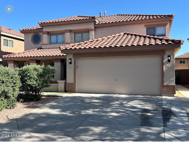 mediterranean / spanish house featuring a garage