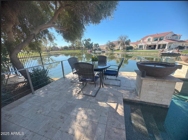 view of patio / terrace with outdoor dining area and a water view