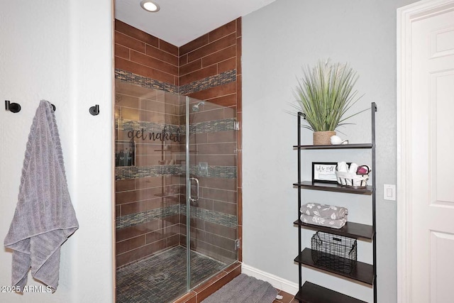 full bath featuring baseboards and a shower stall