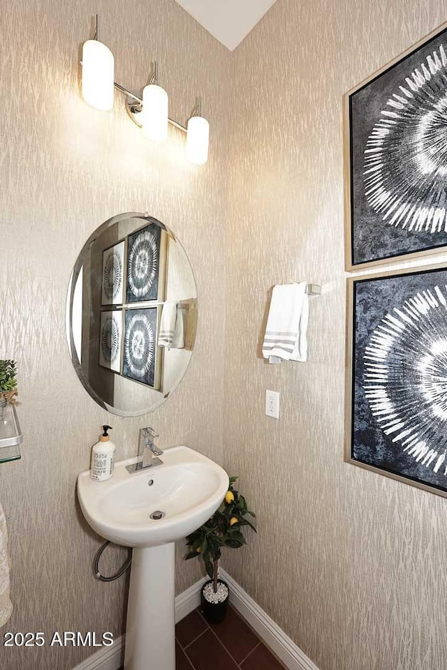 bathroom with tile patterned floors, baseboards, and a sink