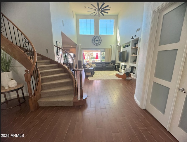 foyer with stairs and dark wood-style flooring