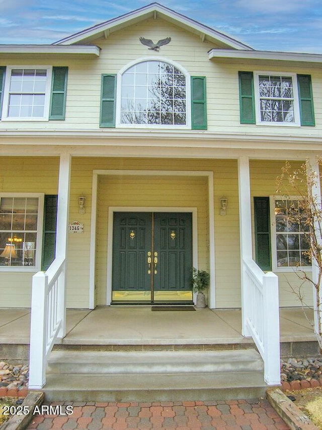 doorway to property featuring a porch