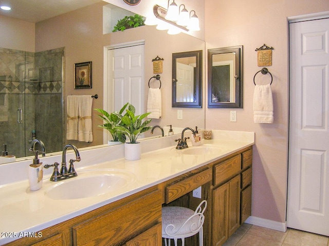 bathroom with vanity, a shower with shower door, and tile patterned floors