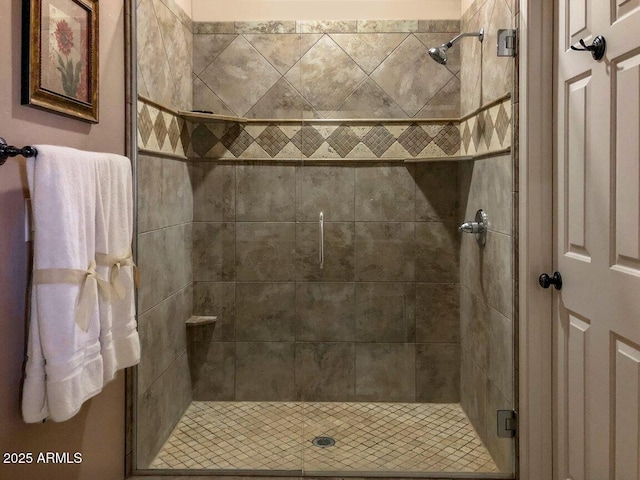 bathroom with a shower with door