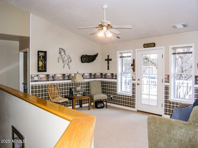 carpeted living room with lofted ceiling and ceiling fan